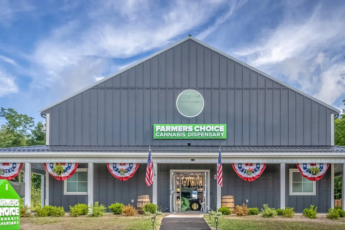 Farmers Choice dispensary building with American flags and green sign