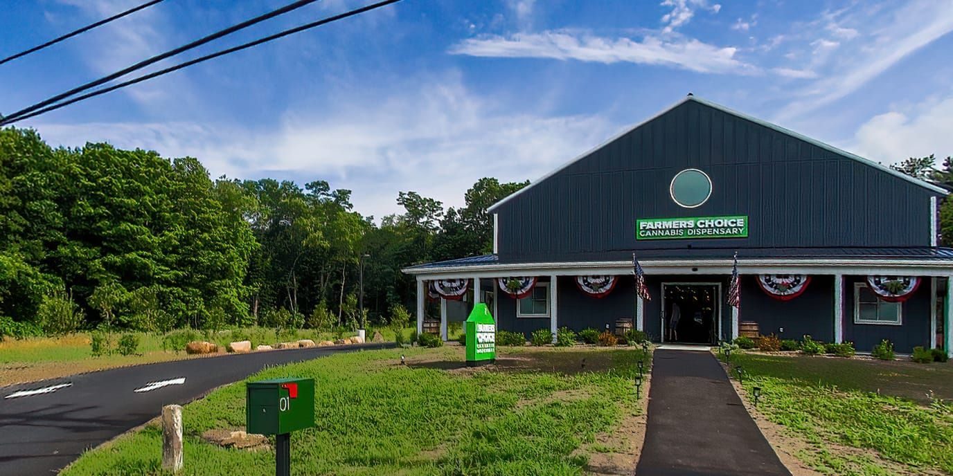 Farmers Choice dispensary building with driveway and green sign